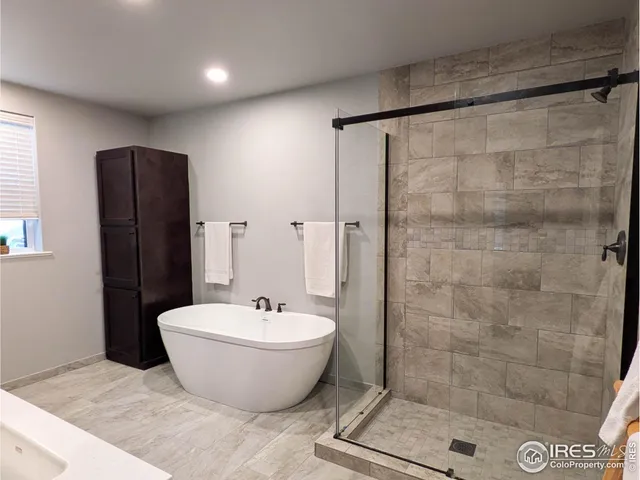 a bathroom with a bathtub and shower