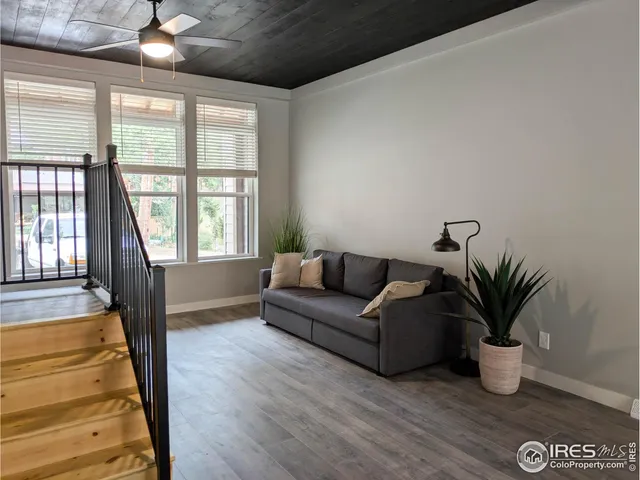 a living room with furniture potted plant and a window