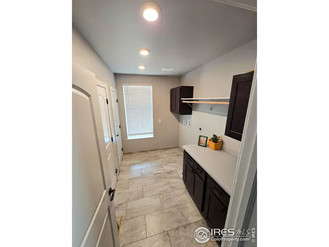a view of a roof deck with wooden fence and trees