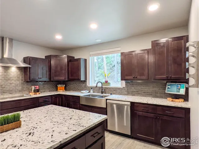 a kitchen with stainless steel appliances granite countertop wooden cabinets a sink and dishwasher