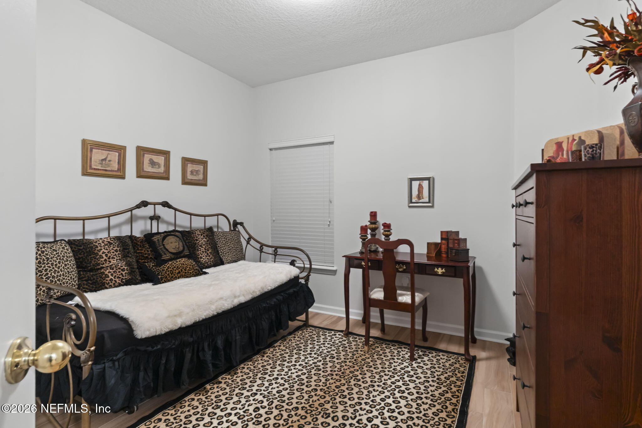 8218 Green Parrot Road, Unit 105 Jacksonville, FL 32256 - Photo 15 of 42 a bedroom with a bed and a table in it