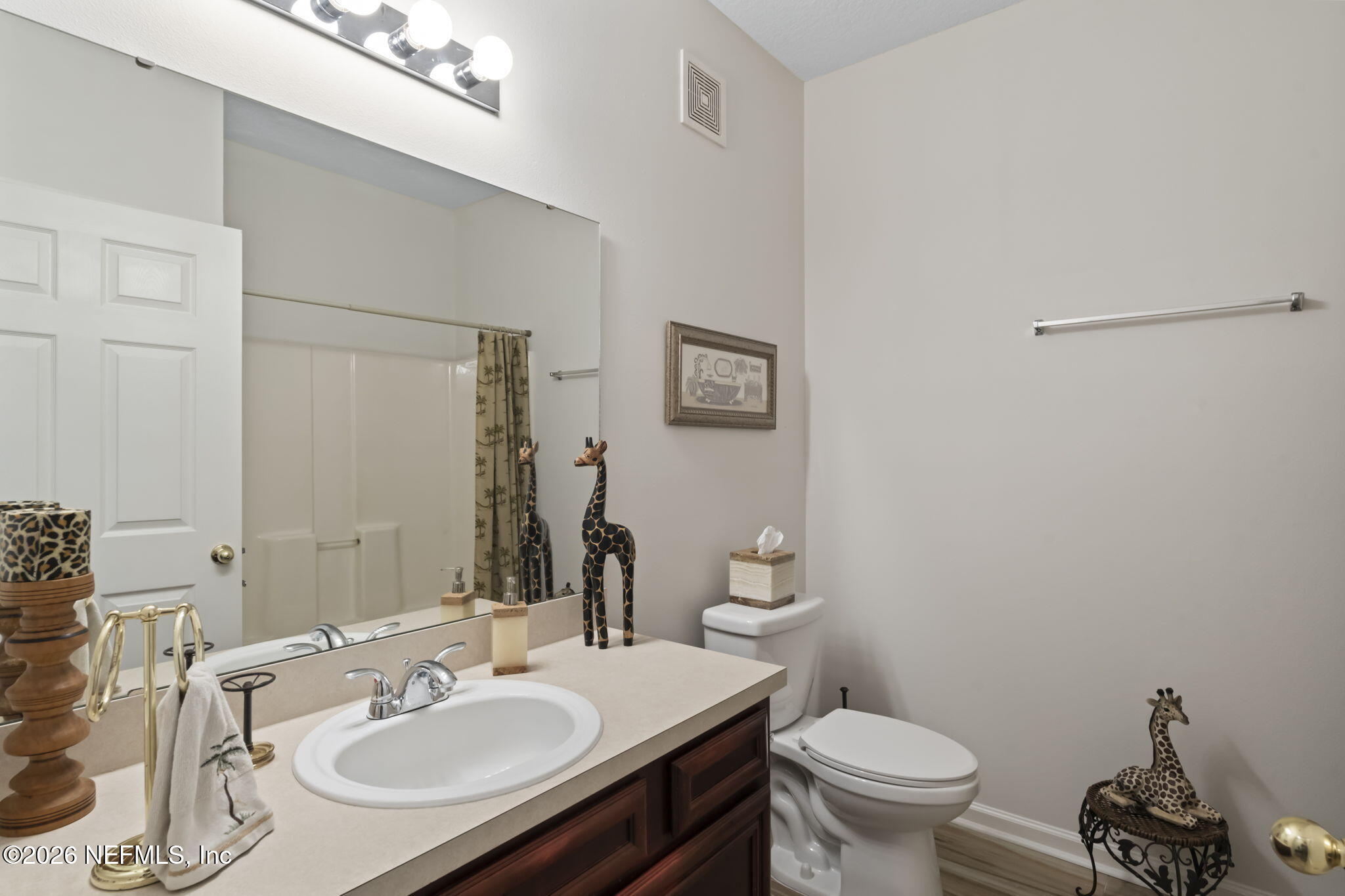 8218 Green Parrot Road, Unit 105 Jacksonville, FL 32256 - Photo 17 of 42 a bathroom with a sink toilet and a mirror