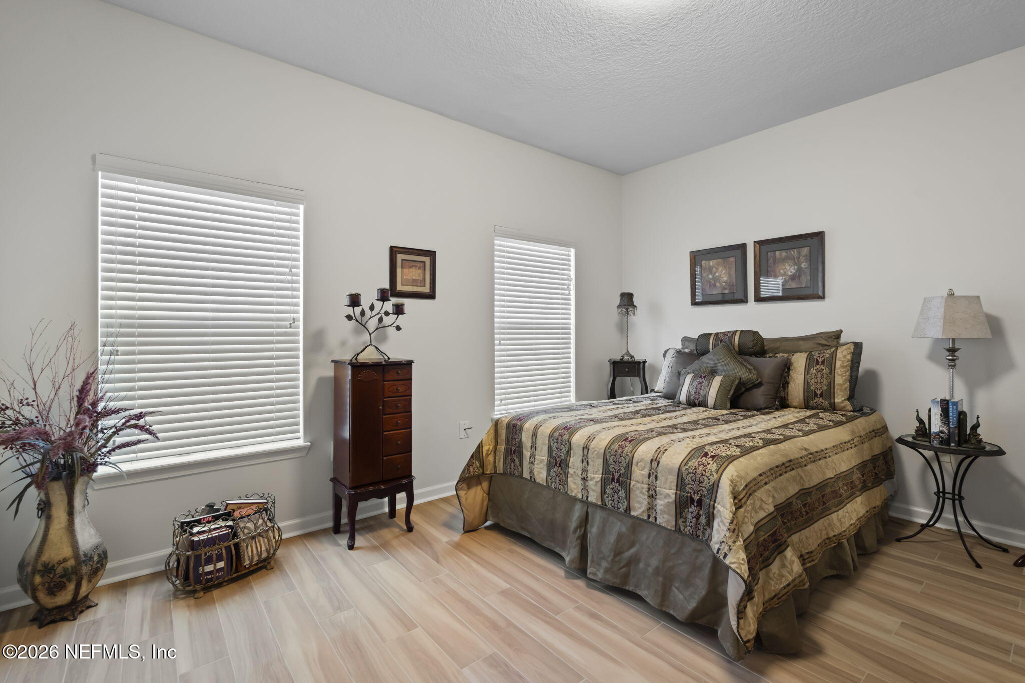 8218 Green Parrot Road, Unit 105 Jacksonville, FL 32256 - Photo 19 of 42 a bedroom with a bed and a potted plant