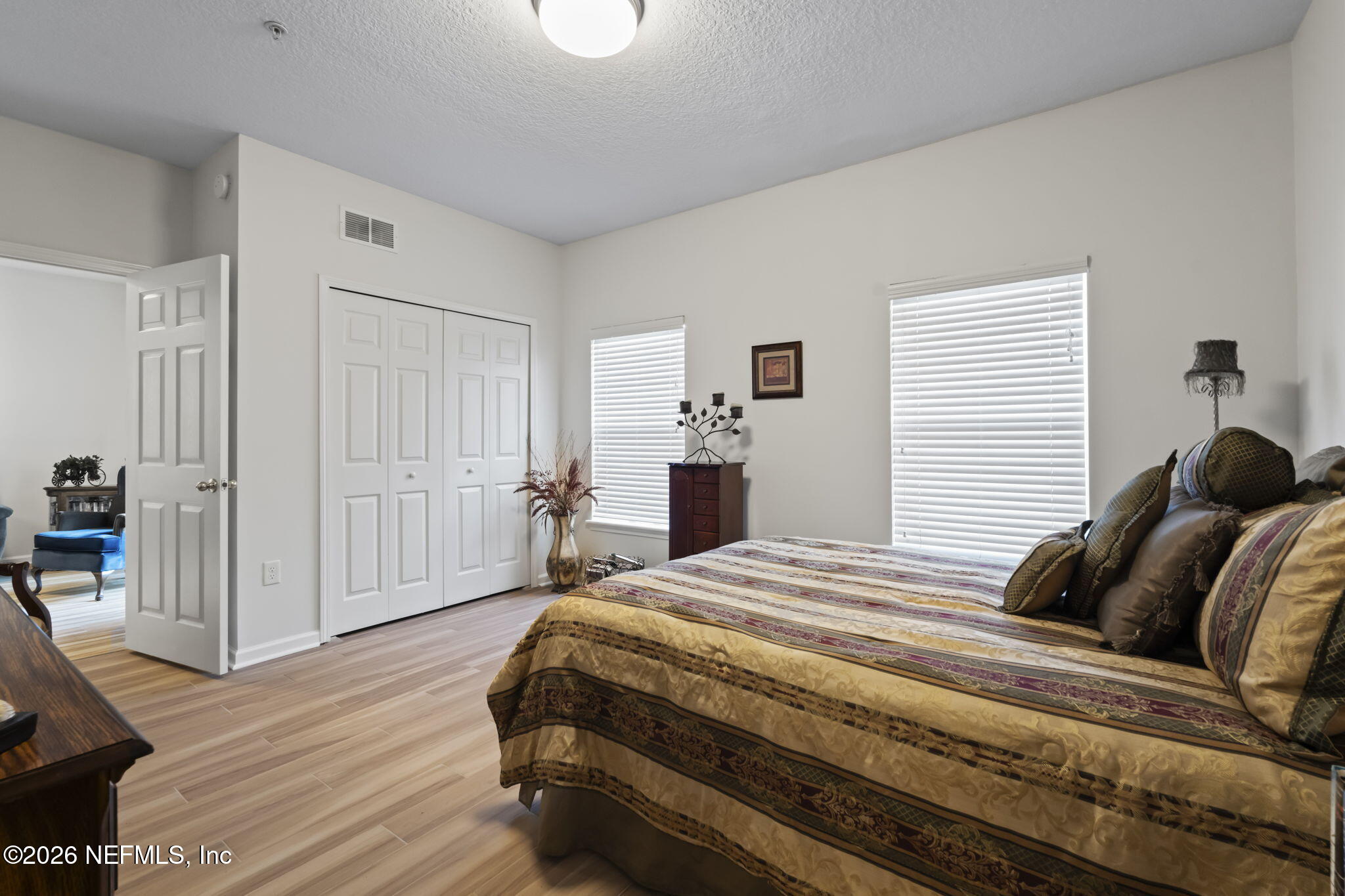 8218 Green Parrot Road, Unit 105 Jacksonville, FL 32256 - Photo 21 of 42 a bedroom with a bed and wooden floor