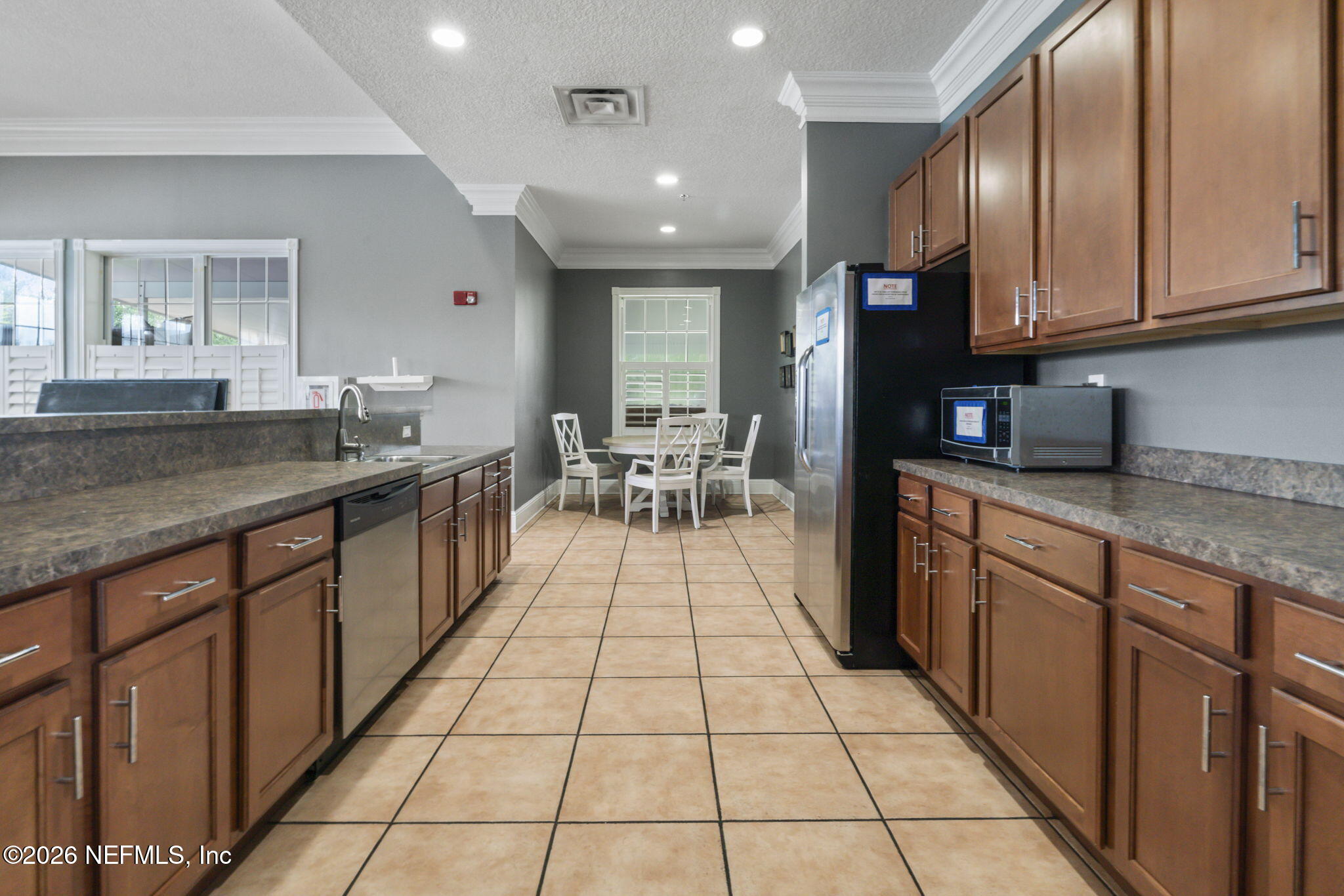 8218 Green Parrot Road, Unit 105 Jacksonville, FL 32256 - Photo 35 of 42 a kitchen with stainless steel appliances granite countertop a sink stove and cabinets
