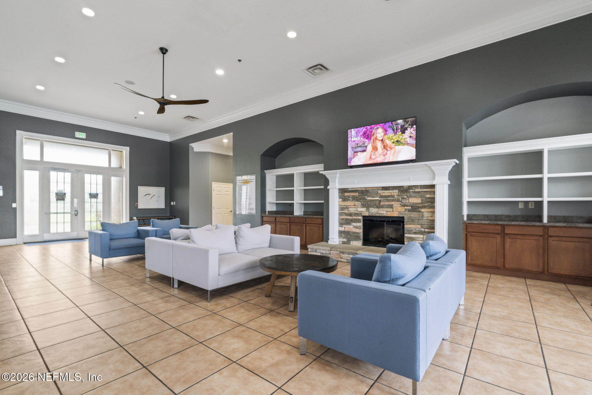 8218 Green Parrot Road, Unit 105 Jacksonville, FL 32256 - Photo 38 of 42 a living room with furniture fireplace and flat screen tv