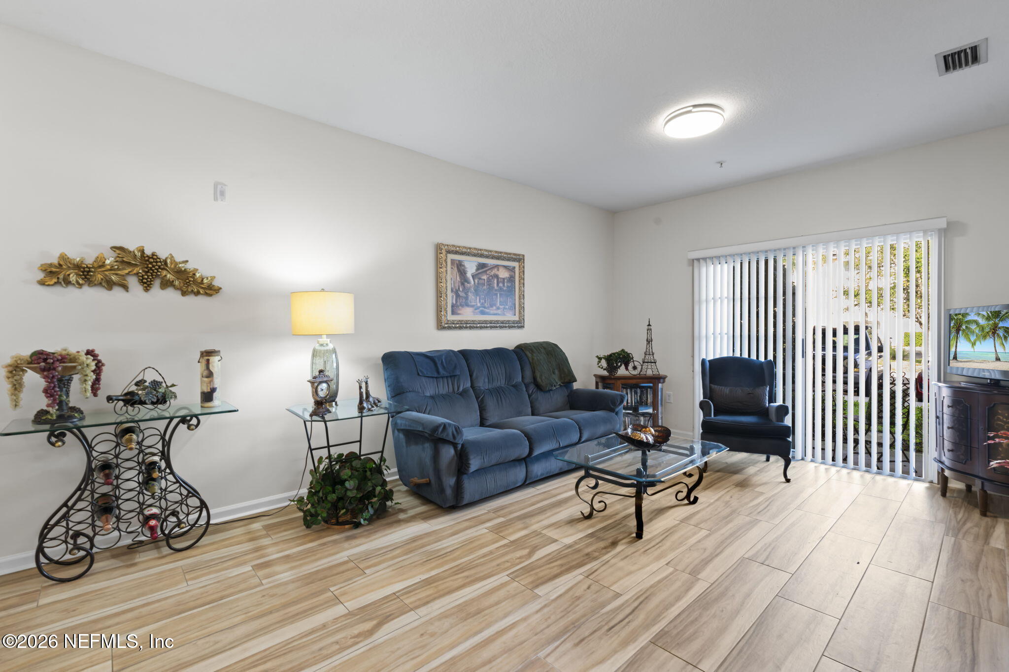 8218 Green Parrot Road, Unit 105 Jacksonville, FL 32256 - Photo 4 of 42 a living room with furniture and wooden floor