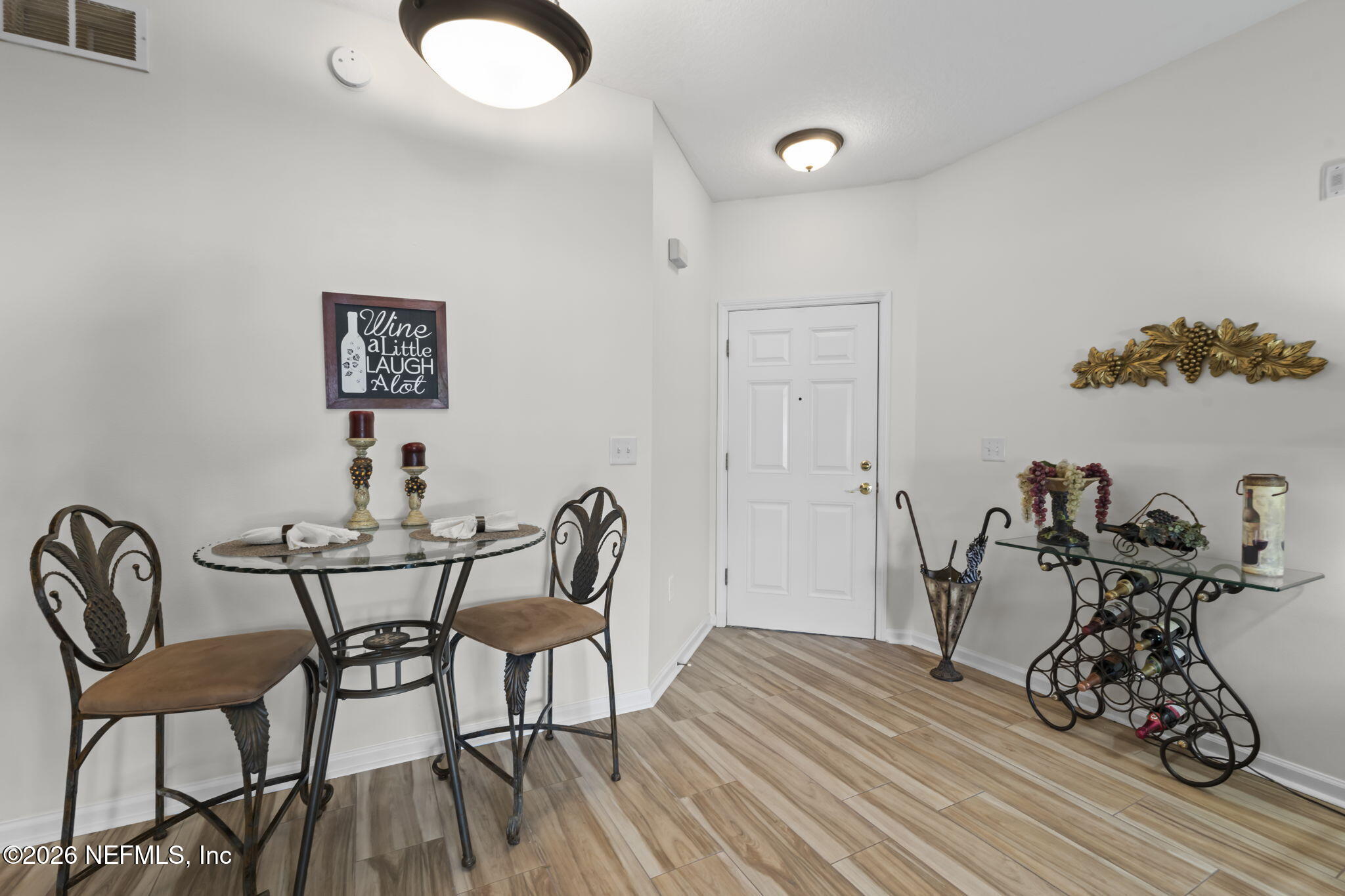 8218 Green Parrot Road, Unit 105 Jacksonville, FL 32256 - Photo 6 of 42 a view of a dining room with furniture and wooden floor