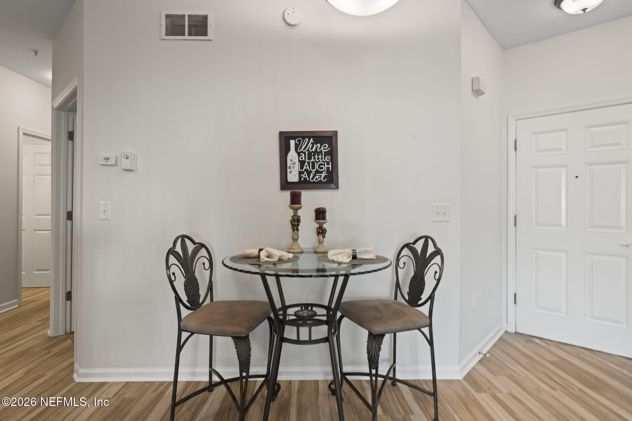 8218 Green Parrot Road, Unit 105 Jacksonville, FL 32256 - Photo 10 of 42 a view of a room that has a table and chairs in it