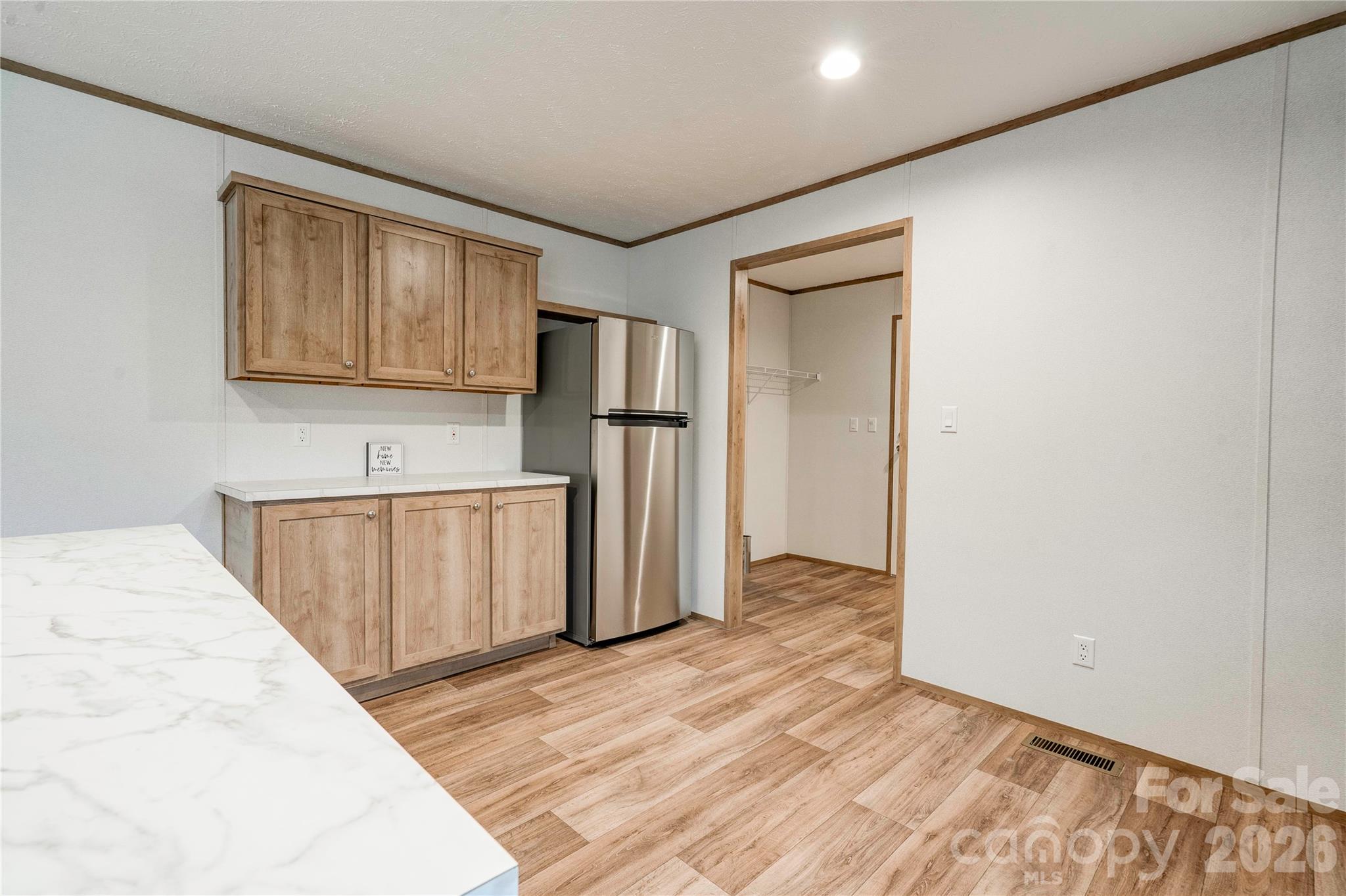 1249 Cleveland Avenue Grover, NC 28073 - Photo 13 of 34 a view of a kitchen with wooden cabinets and refrigerator