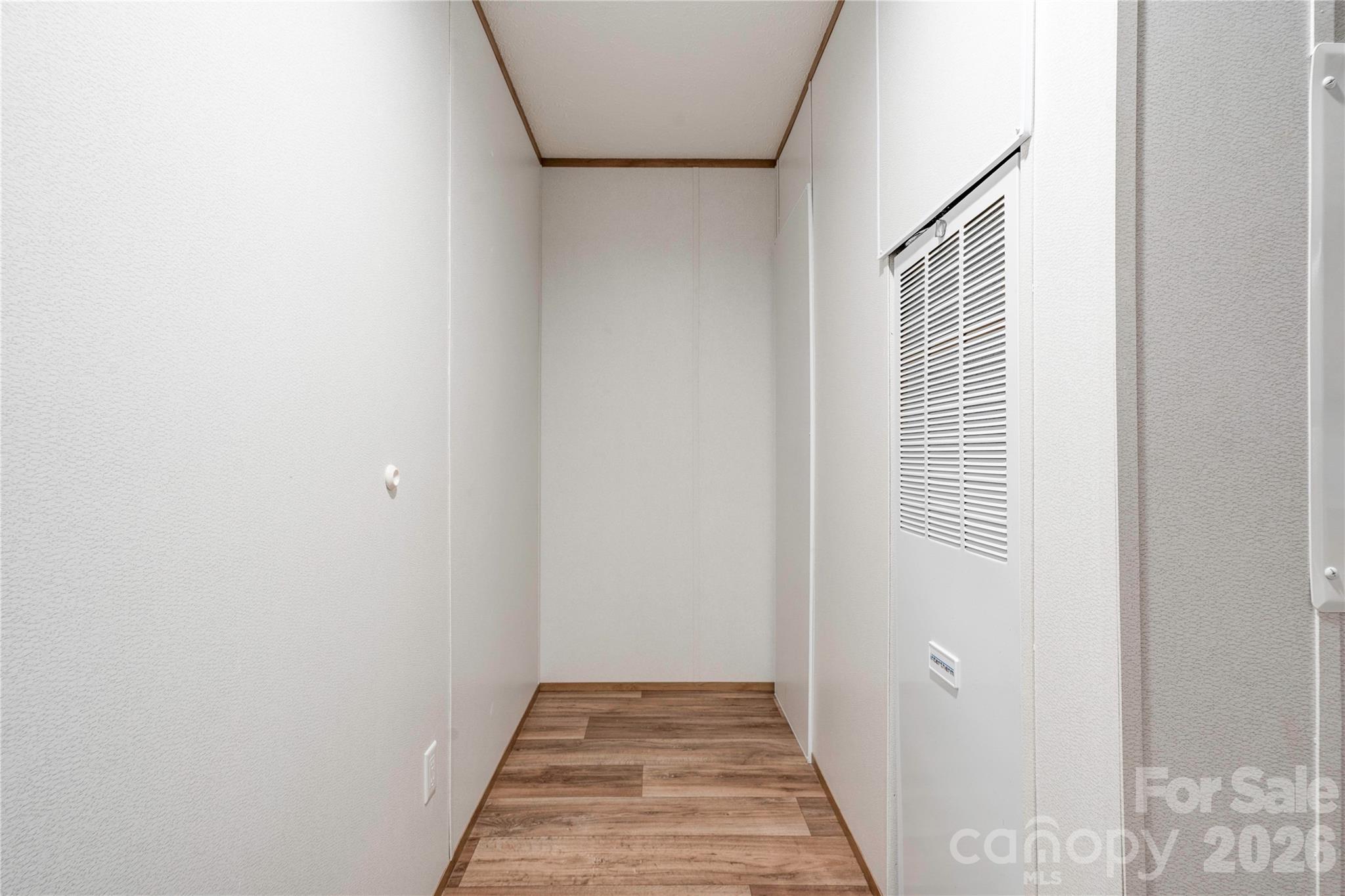 1249 Cleveland Avenue Grover, NC 28073 - Photo 15 of 34 a view of a hallway with wooden floor and a bathroom