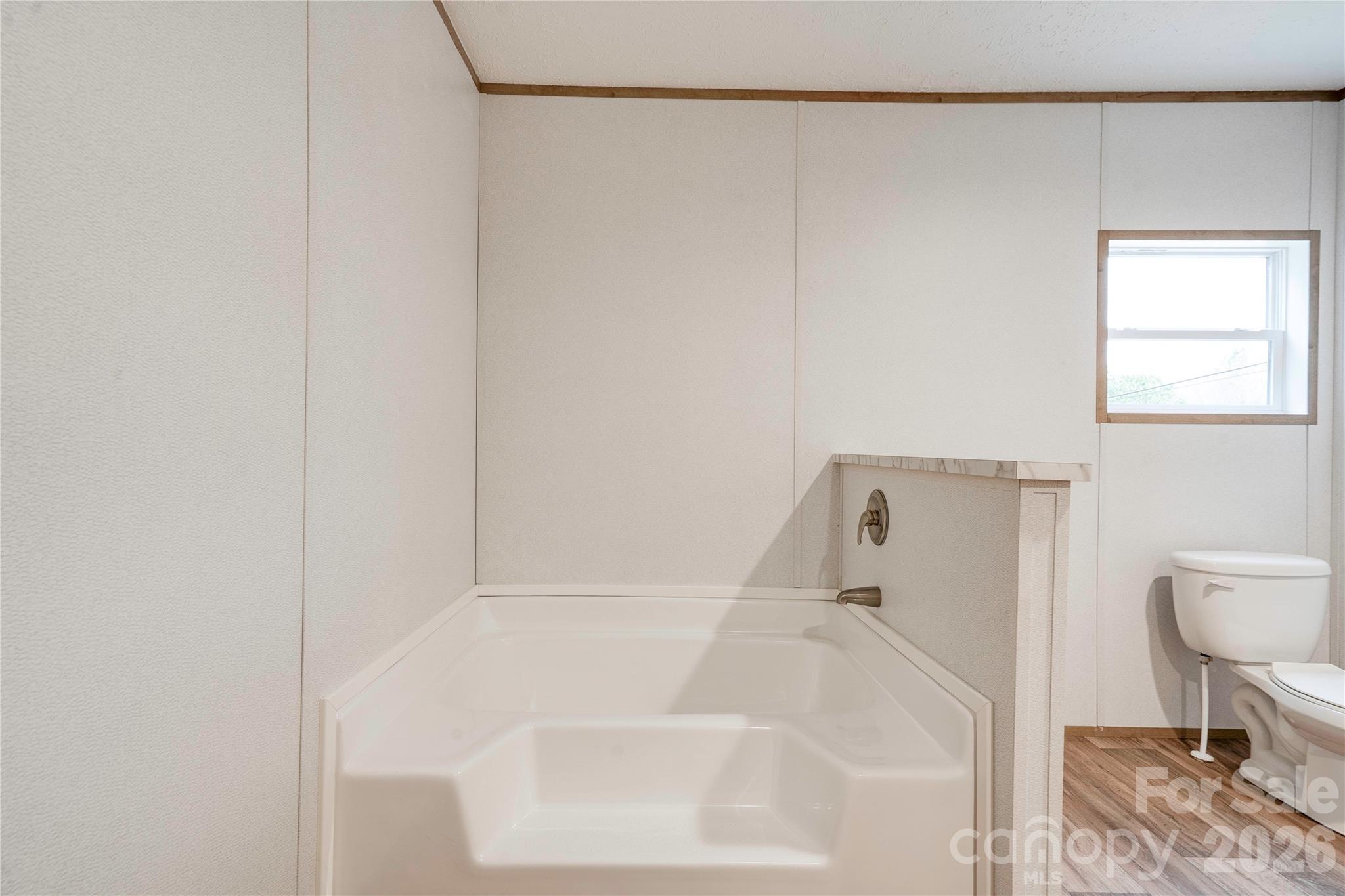 1249 Cleveland Avenue Grover, NC 28073 - Photo 22 of 34 a bathroom with a bathtub and a toilet