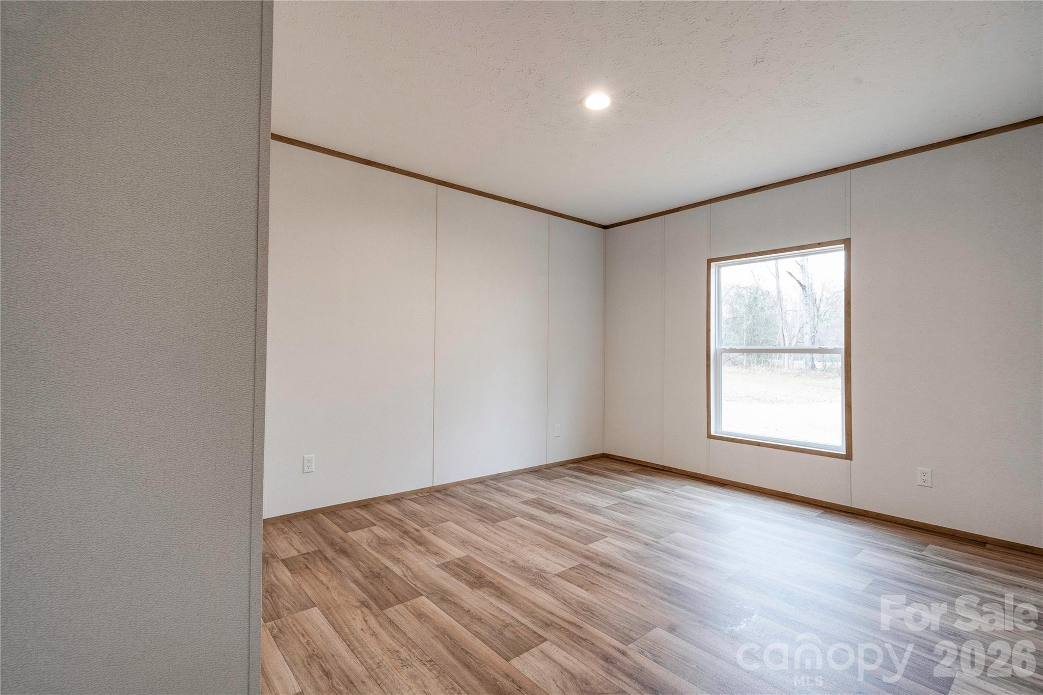 1249 Cleveland Avenue Grover, NC 28073 - Photo 25 of 34 an empty room with wooden floor and windows