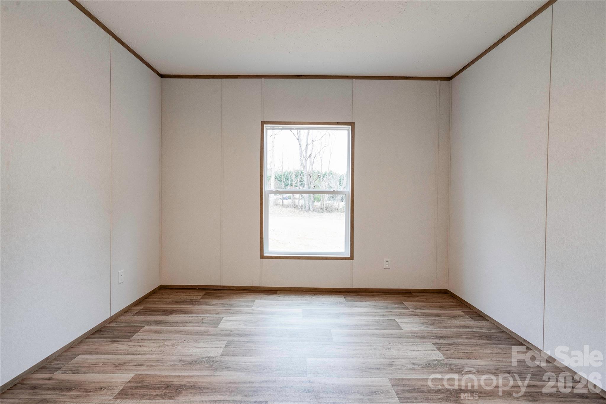 1249 Cleveland Avenue Grover, NC 28073 - Photo 27 of 34 an empty room with wooden floor and window
