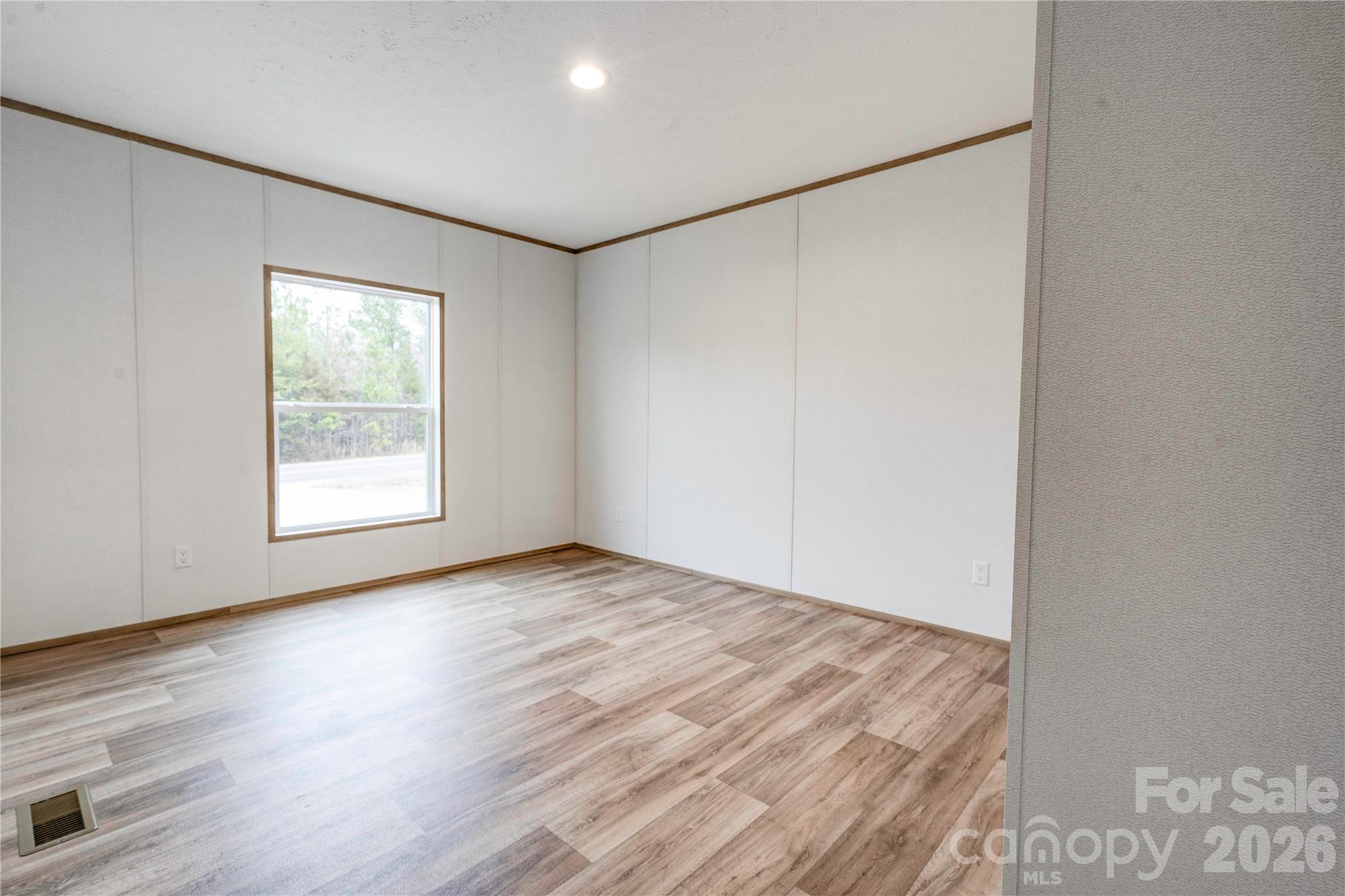 1249 Cleveland Avenue Grover, NC 28073 - Photo 28 of 34 a view of an empty room with wooden floor and a window