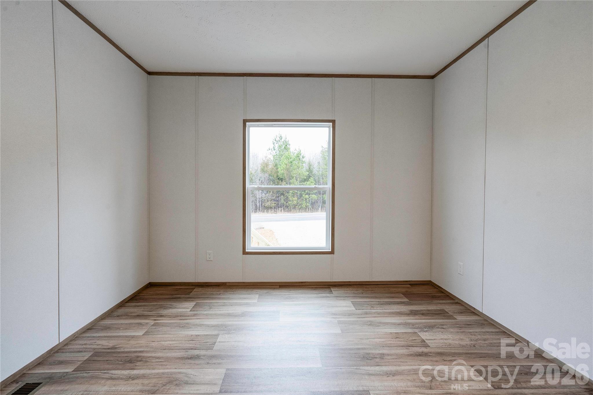 1249 Cleveland Avenue Grover, NC 28073 - Photo 29 of 34 an empty room with wooden floor and window