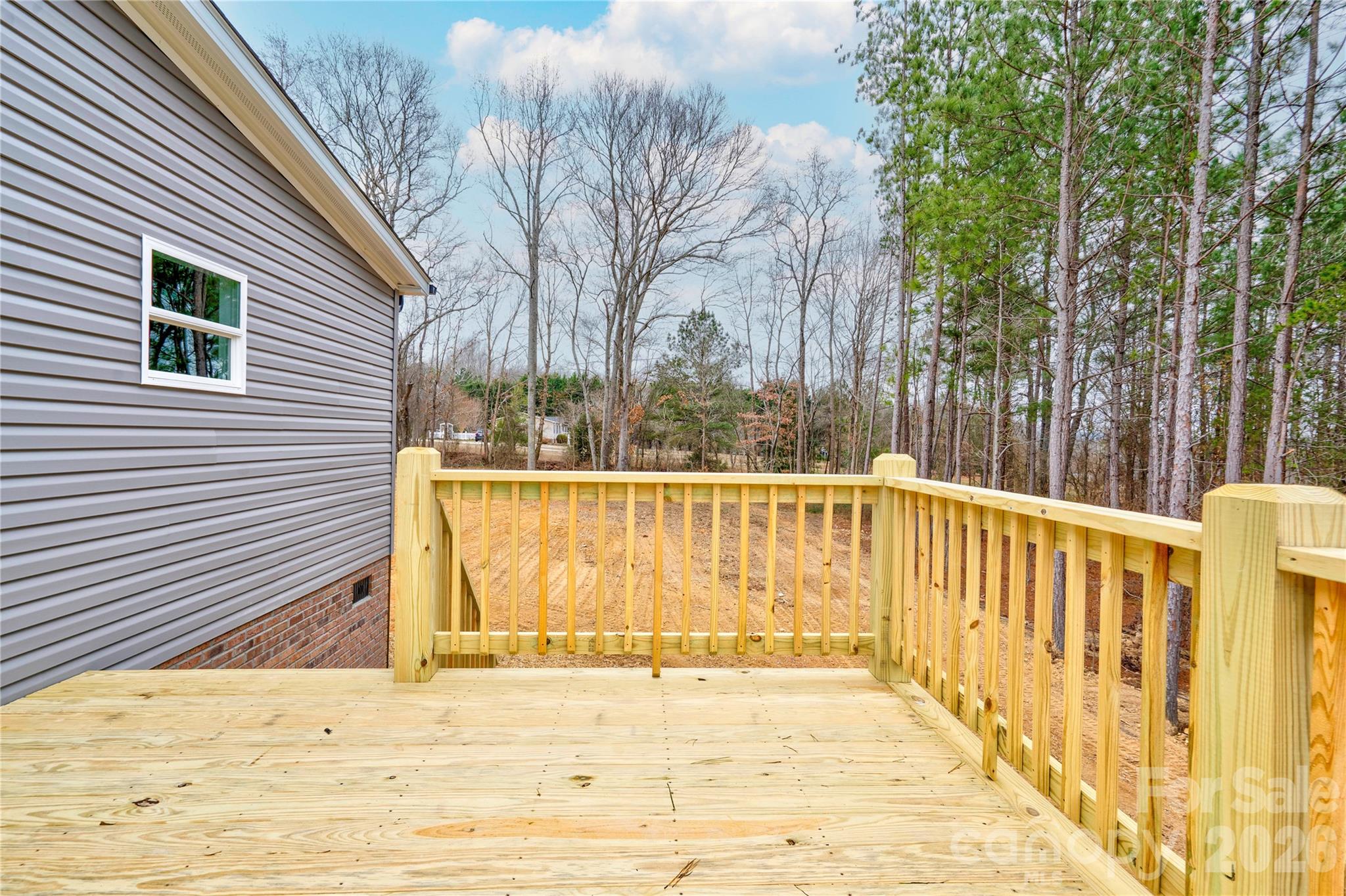 1249 Cleveland Avenue Grover, NC 28073 - Photo 30 of 34 a view of a balcony with wooden fence and trees