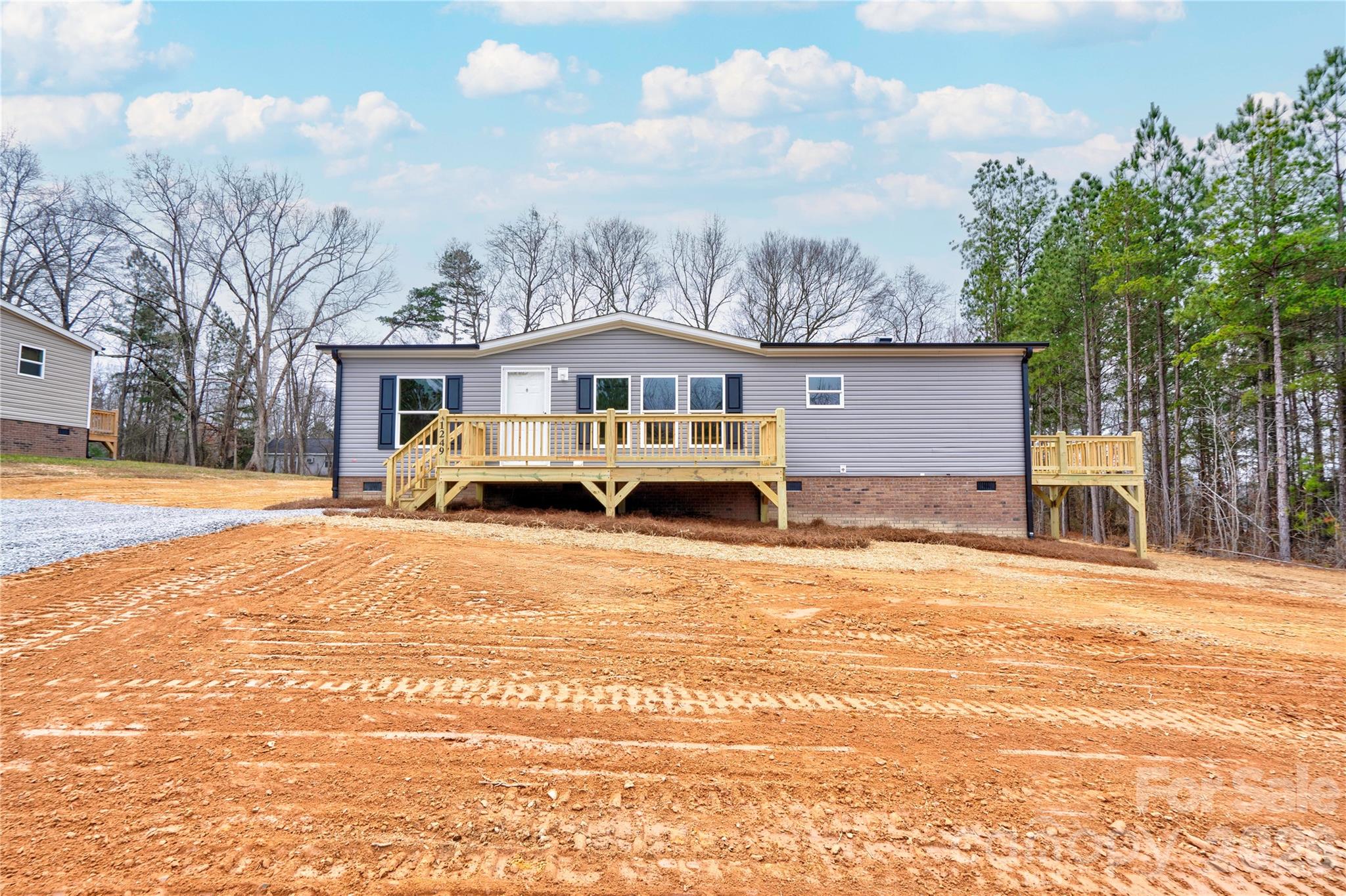 1249 Cleveland Avenue Grover, NC 28073 - Photo 3 of 34 a front view of a house with a yard covered with snow and trees