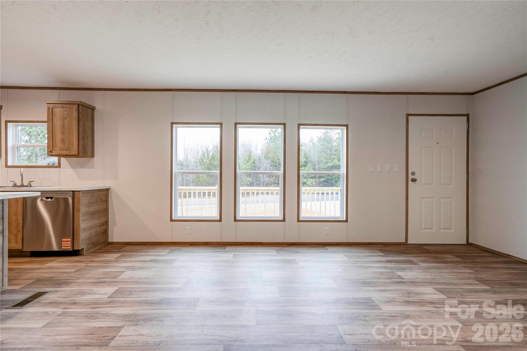 1249 Cleveland Avenue Grover, NC 28073 - Photo 5 of 34 an empty room with wooden floor and windows