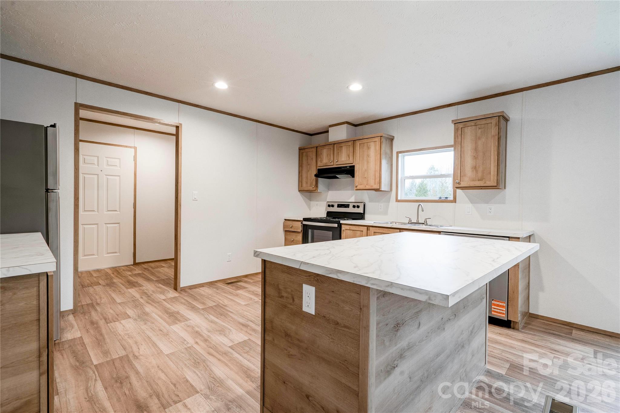 1249 Cleveland Avenue Grover, NC 28073 - Photo 9 of 34 a kitchen with a sink a stove and a refrigerator
