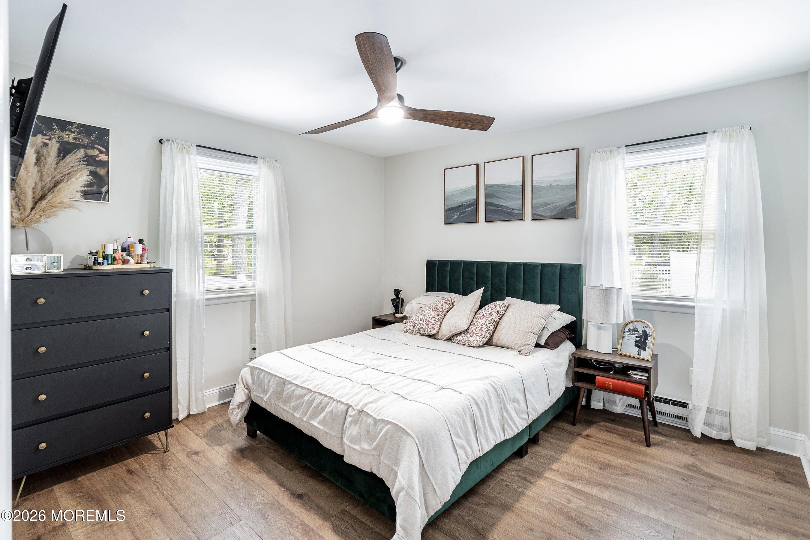 329 Briggs Avenue Forked River, NJ 08731 - Photo 13 of 16 a bedroom with a large bed and a window