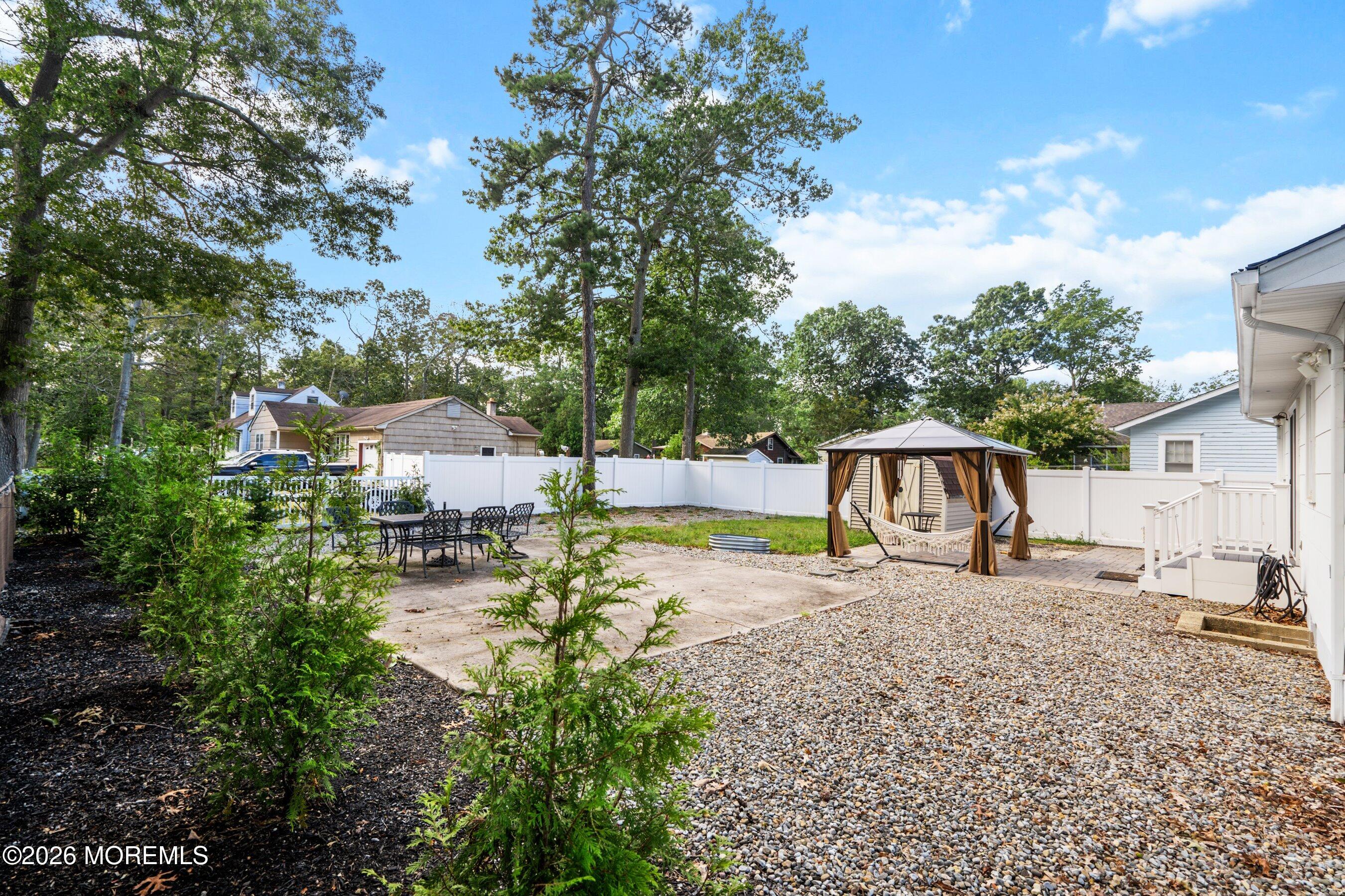 329 Briggs Avenue Forked River, NJ 08731 - Photo 15 of 16 a backyard of a house with table and chairs
