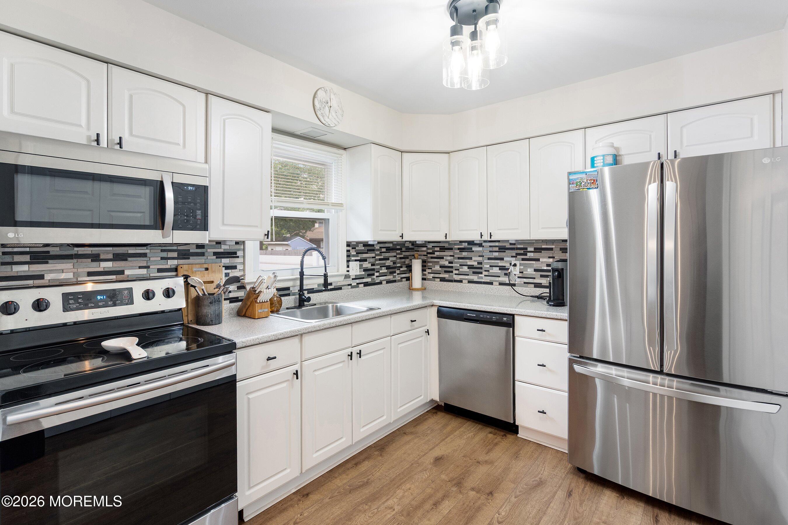 329 Briggs Avenue Forked River, NJ 08731 - Photo 7 of 16 a kitchen with stainless steel appliances a refrigerator stove and sink