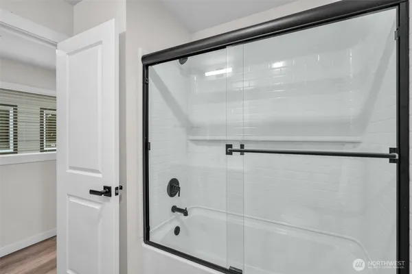 a bathroom with a glass shower door