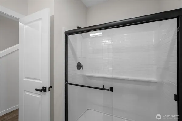 a bathroom with a glass shower door