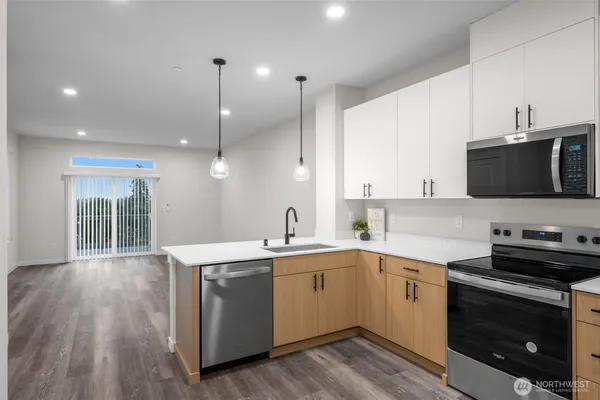 a kitchen with a sink a stove and microwave