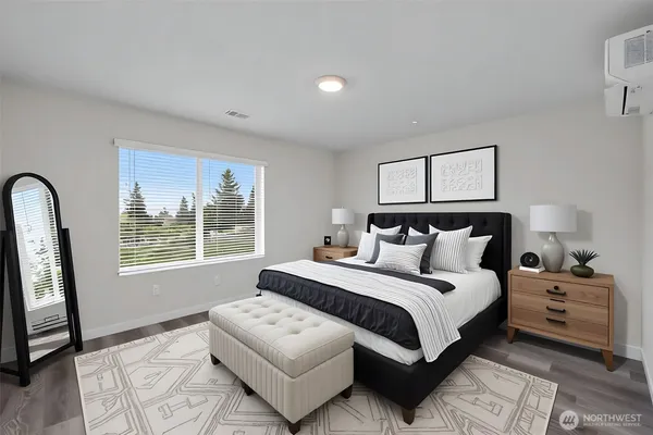 a bedroom with bed and a large window