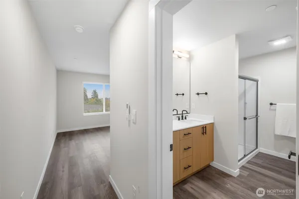 an empty room with wooden floor and mirror