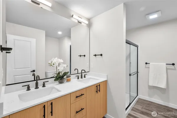 a bathroom with a double vanity sink mirror and double