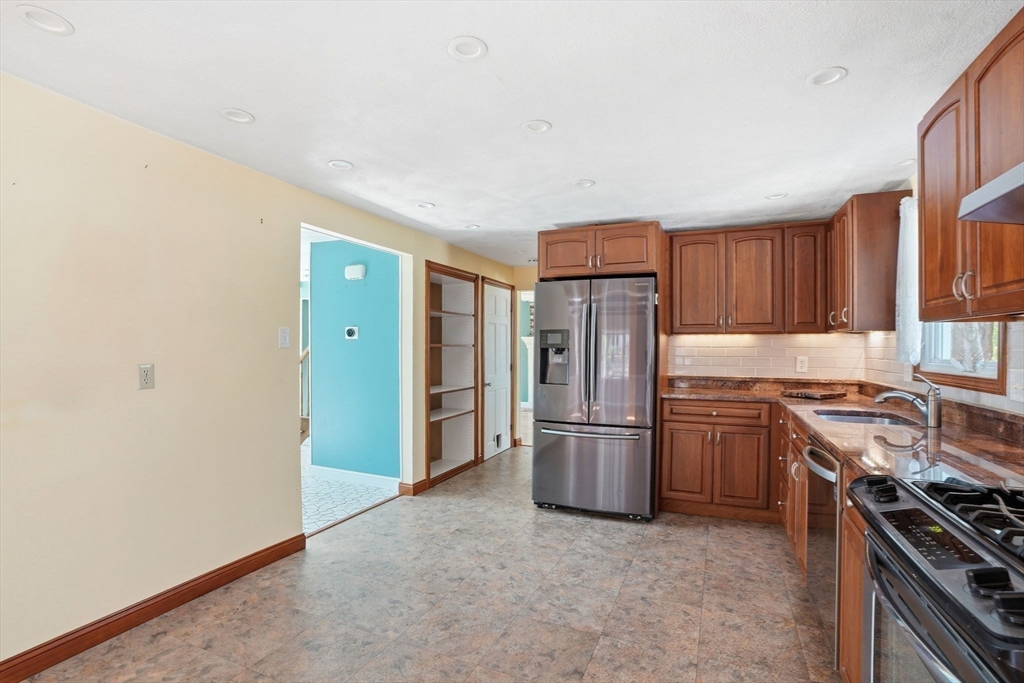 3 Fairway Drive Canton, MA 02021 - Photo 5 of 34 a kitchen with stainless steel appliances granite countertop a refrigerator stove and sink