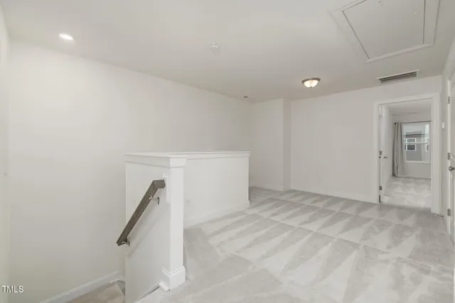 a view of entryway and gallery with wooden floor