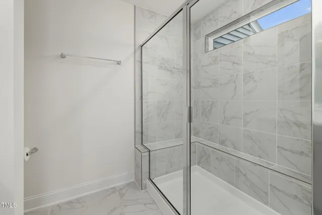 a bathroom with a glass shower door