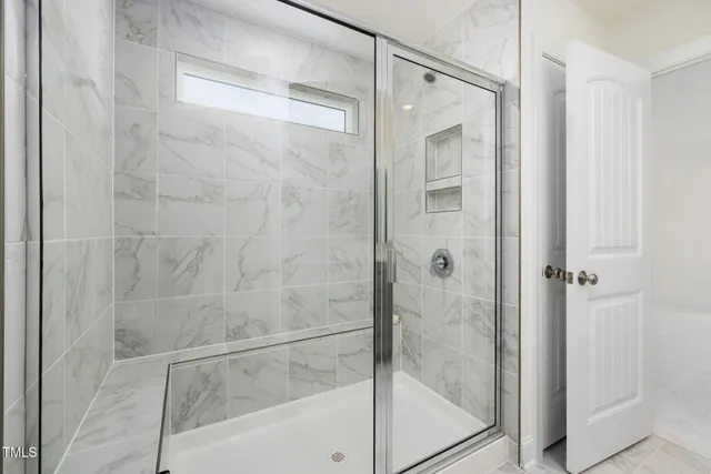 a bathroom with a glass shower door
