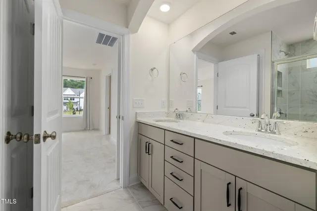 a bathroom with a granite countertop sink mirror and double