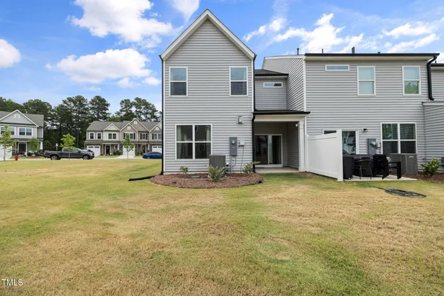 a view of a house with a swimming pool and a yard