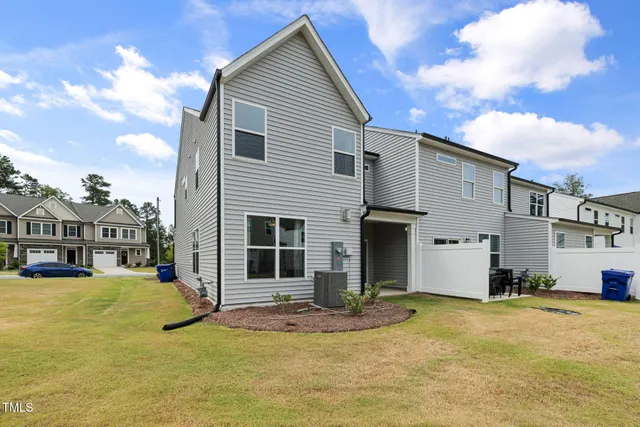 a view of a house with swimming pool and a yard
