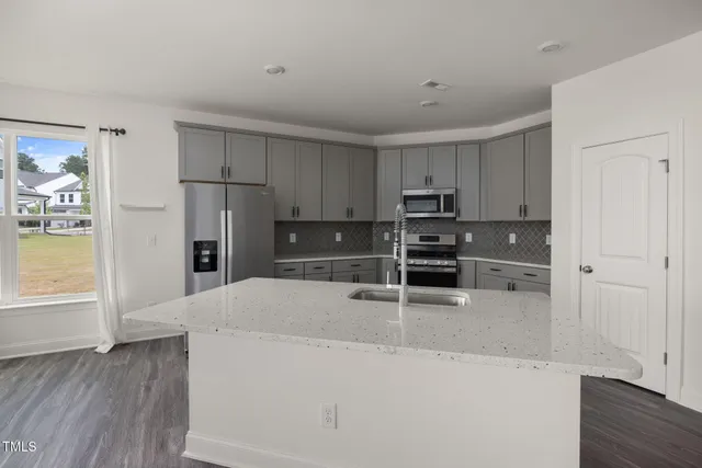a bathroom with a granite countertop toilet sink and mirror