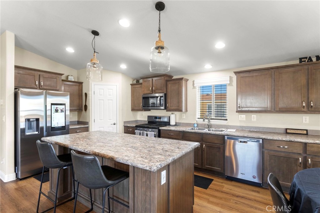 22241 Nisqually Road, Unit 103 Apple Valley, CA 92308 - Photo 9 of 34 Bright kitchen with island, cabinetry, and modern finishes