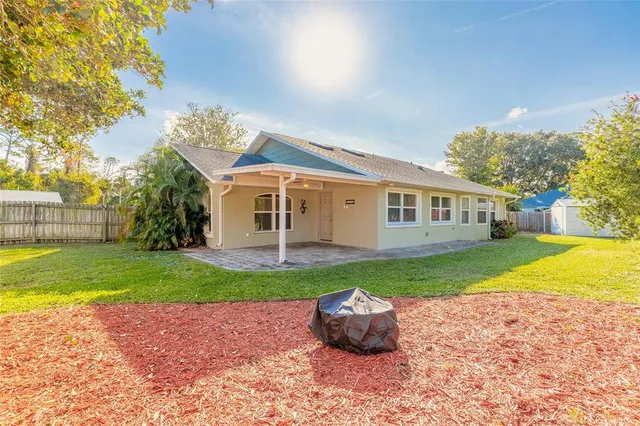 a view of a house with a yard and a garden