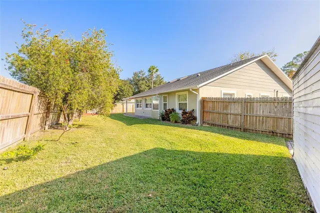 a view of a house with swimming pool and a yard