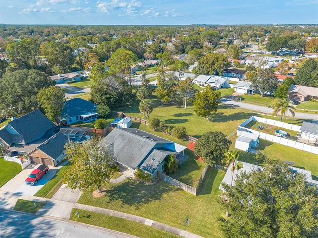 an aerial view of residential houses with outdoor space