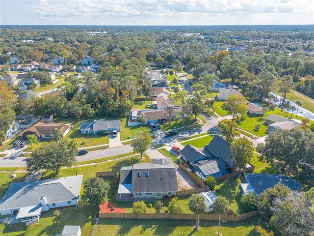 an aerial view of residential houses with outdoor space and swimming pool