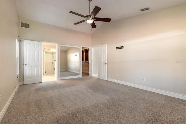 a view of a livingroom with a ceiling fan a ceiling fan and a window