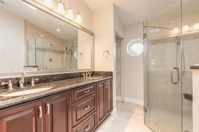 a bathroom with a granite countertop sink mirror and double