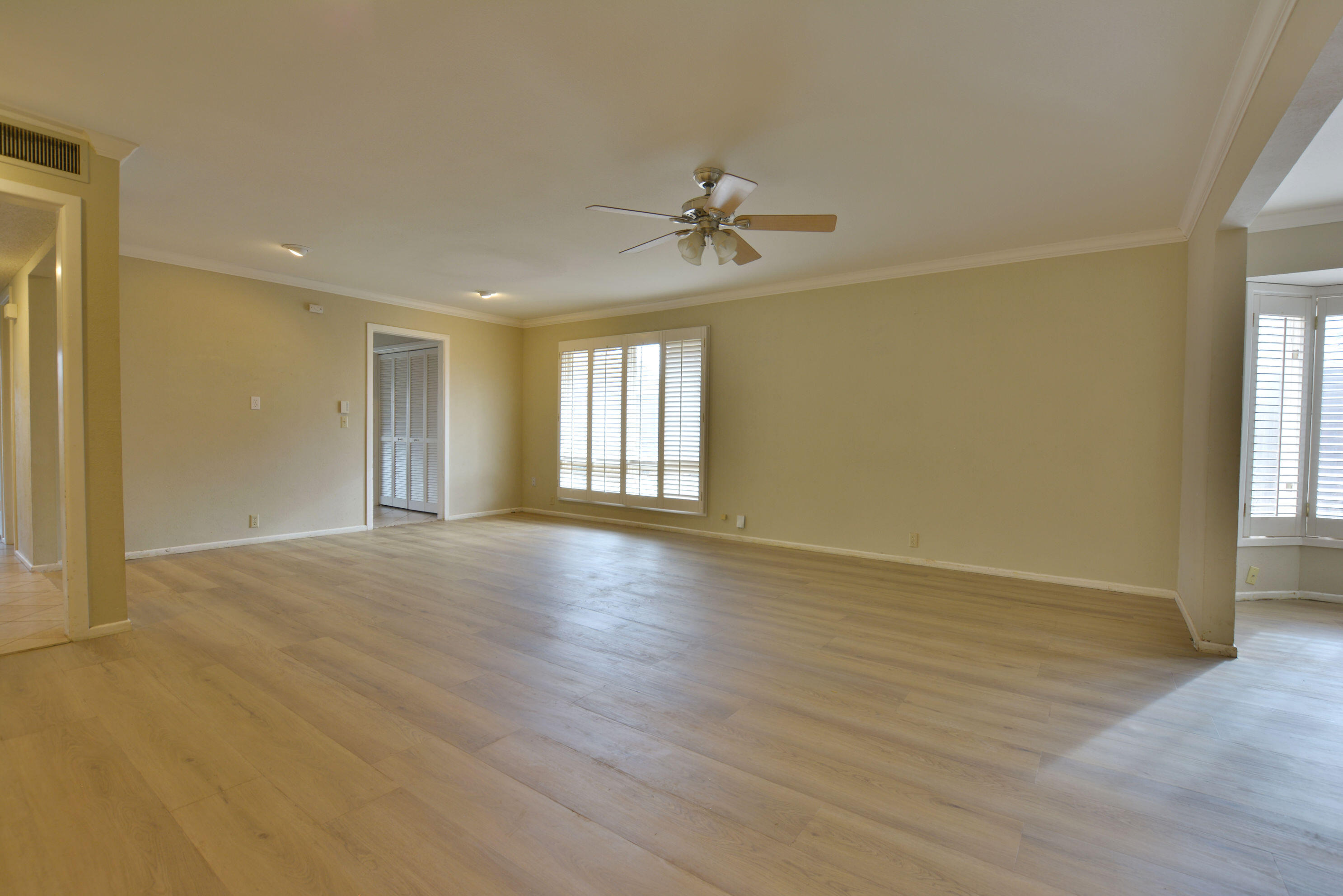 3307 74th Street, Unit A Lubbock, TX 79423 - Photo 17 of 19 a view of an empty room with window and wooden floor