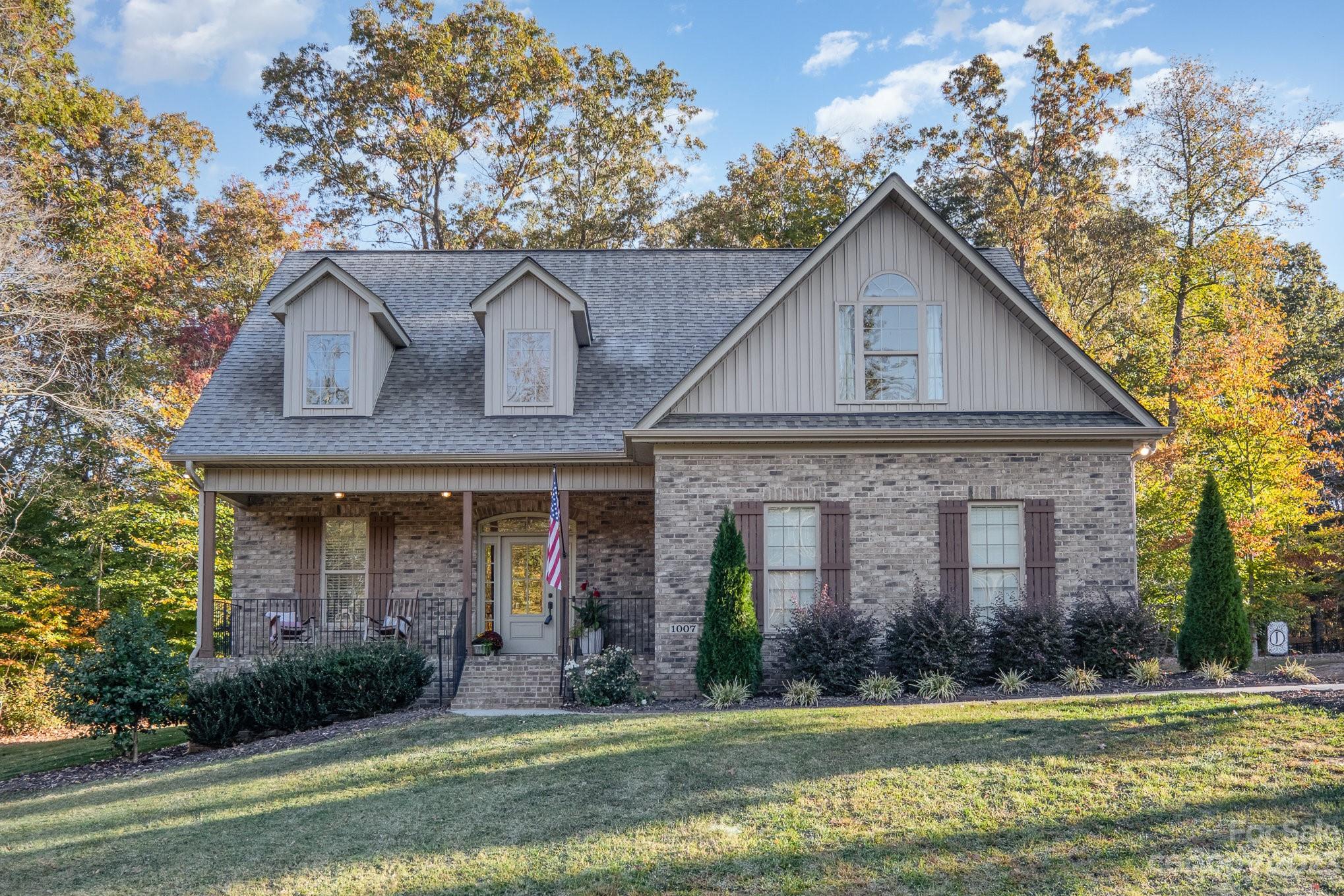 1007 Flat Rock Drive Monroe, NC 28110 - Photo 1 of 34 a front view of a house with a yard and garage